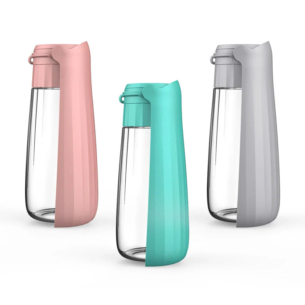 Portable outdoor dog water bottle with large 550ml capacity, available in various colors including lake blue, pink, and gray.