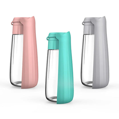 Portable outdoor dog water bottle with large 550ml capacity, available in various colors including lake blue, pink, and gray.