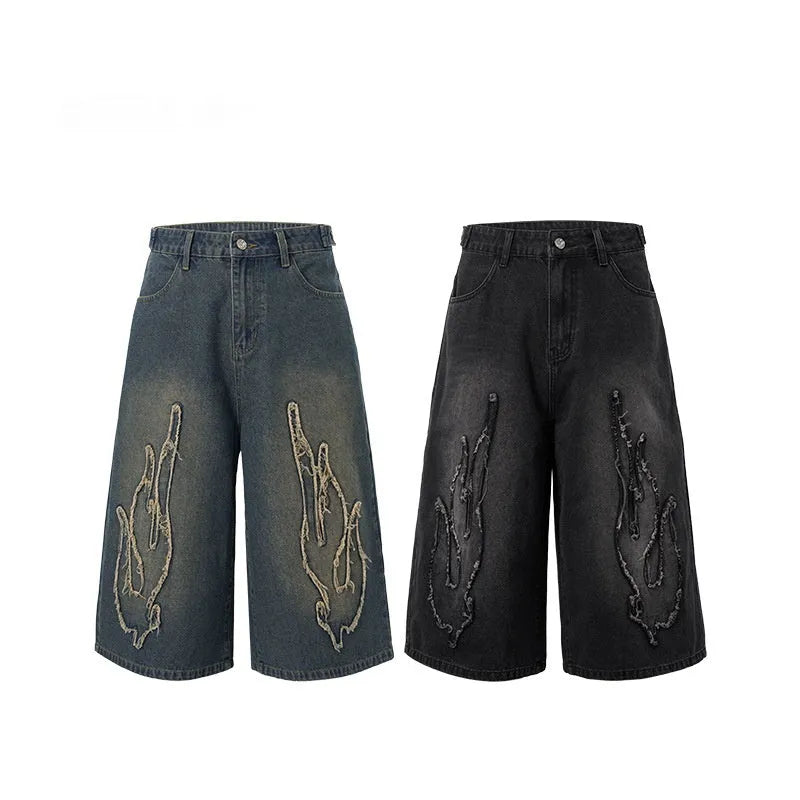 Men's cropped denim shorts with flame embroidery patch in black and blue colours, straight cut for summer street style