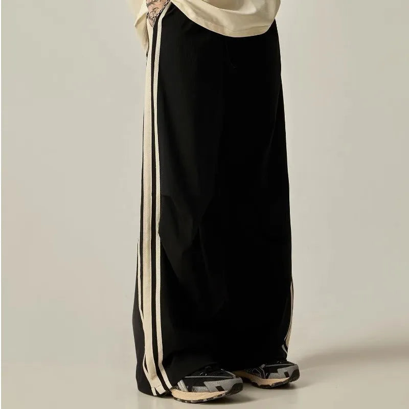Men's black high-waist wide-leg climbing trousers with straight leg on a plain background.