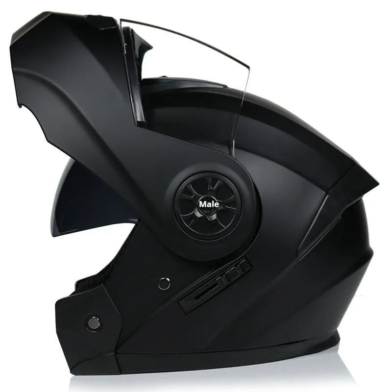 Matte black full face motorcycle helmet with integrated battery visor on a stand