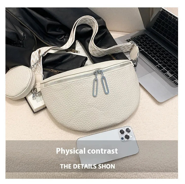 Solid colour women's crossbody bag with saddle lock zipper texture in a horizontal square clamshell shape.