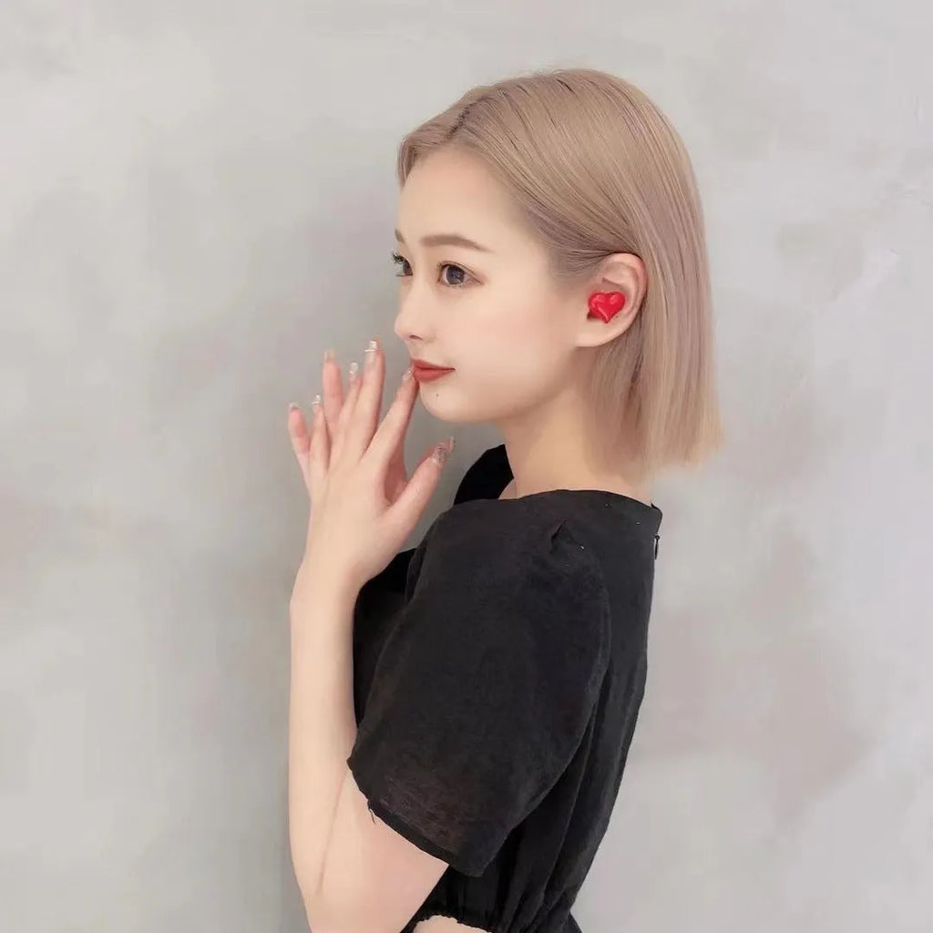 Heart-shaped wireless Bluetooth headphones in red or pink colours with earplug design