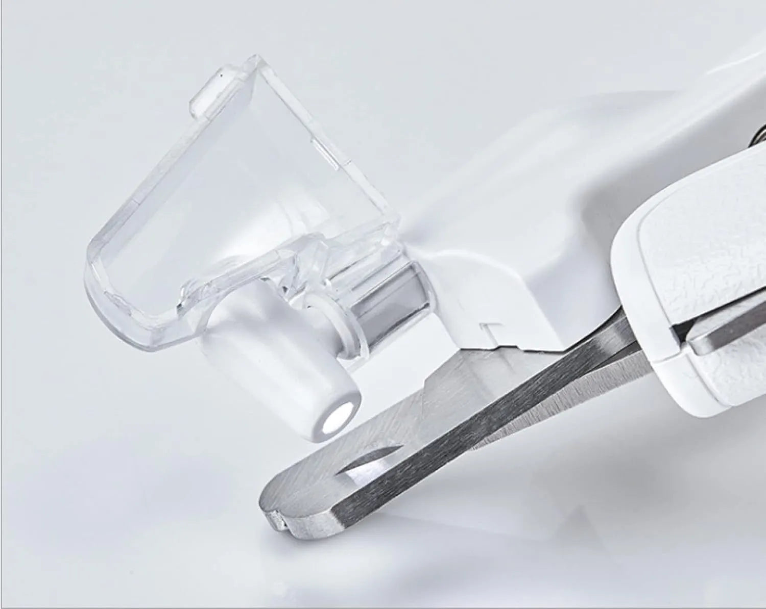 White LED pet nail clippers with a transparent anti-splash guard and an integrated nail file on a grey background.