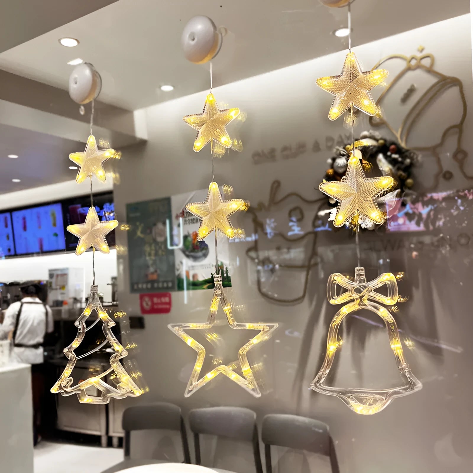 Three Christmas LED pendant lights with suction cups showing star, tree, and snowflake designs
