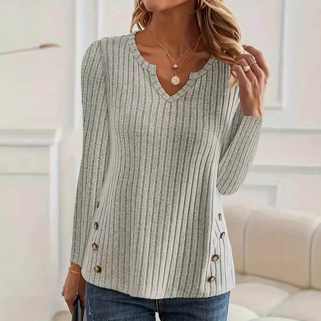 A simple solid colour knitted pullover sweater with button detailing on the front.