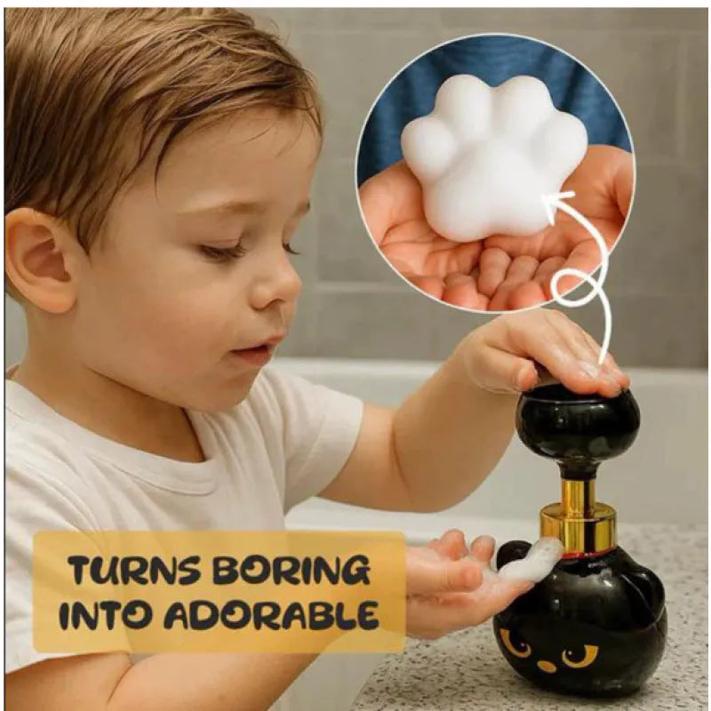Black plastic cartoon cat shaped foam soap dispenser on a bathroom counter.