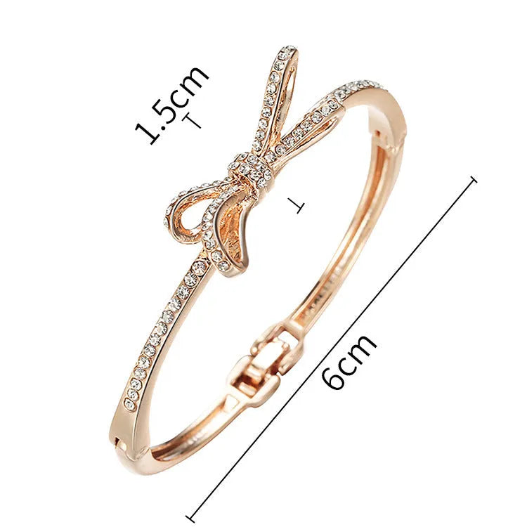 Women's rose gold bow bracelet made from electroplated copper with a diamond feature