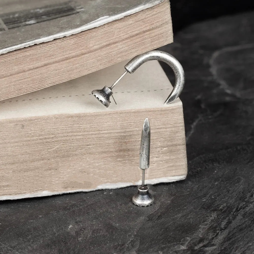 Sterling silver nail-shaped stud earrings with punk retro design