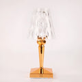 Rose gold portable touch night light on a surface showing its dimmable glow.