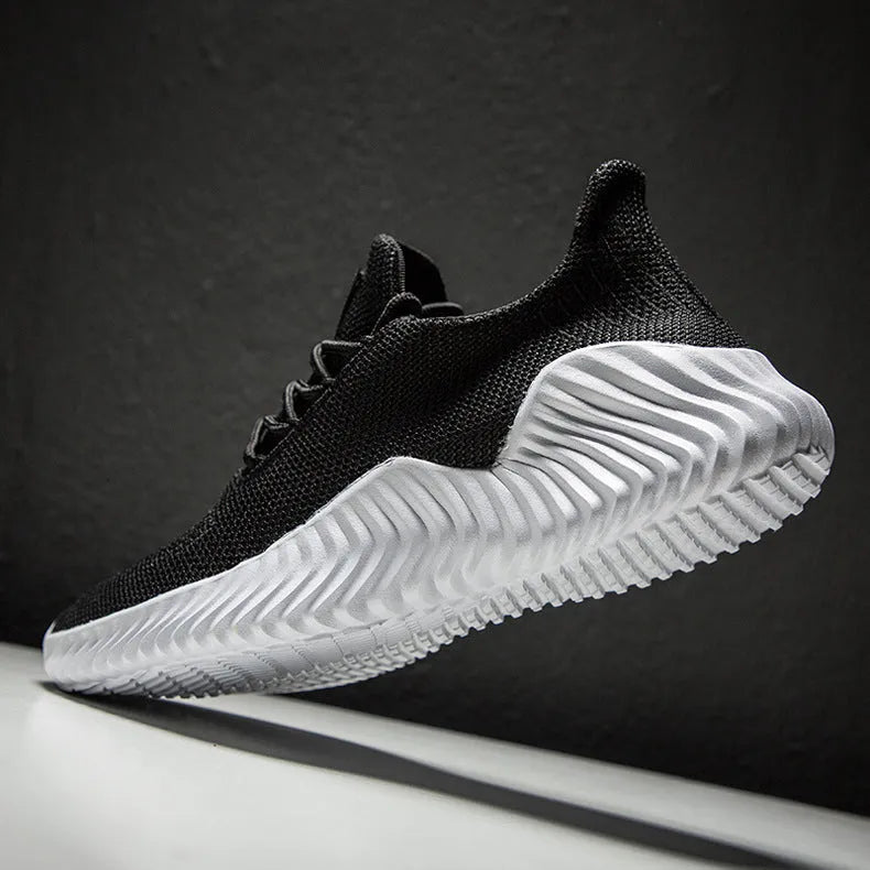 Men's breathable ultra-light running shoes with white upper and grey sole, side view