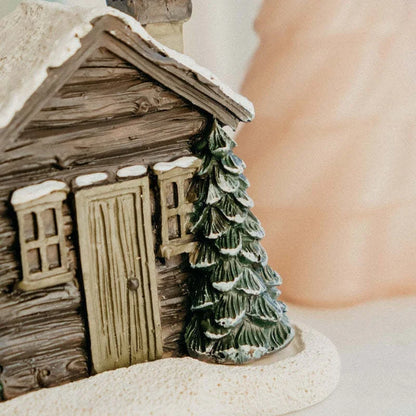 Rustic log cabin-shaped incense burner with wood-inspired finish, creating a cozy and inviting atmosphere in the home