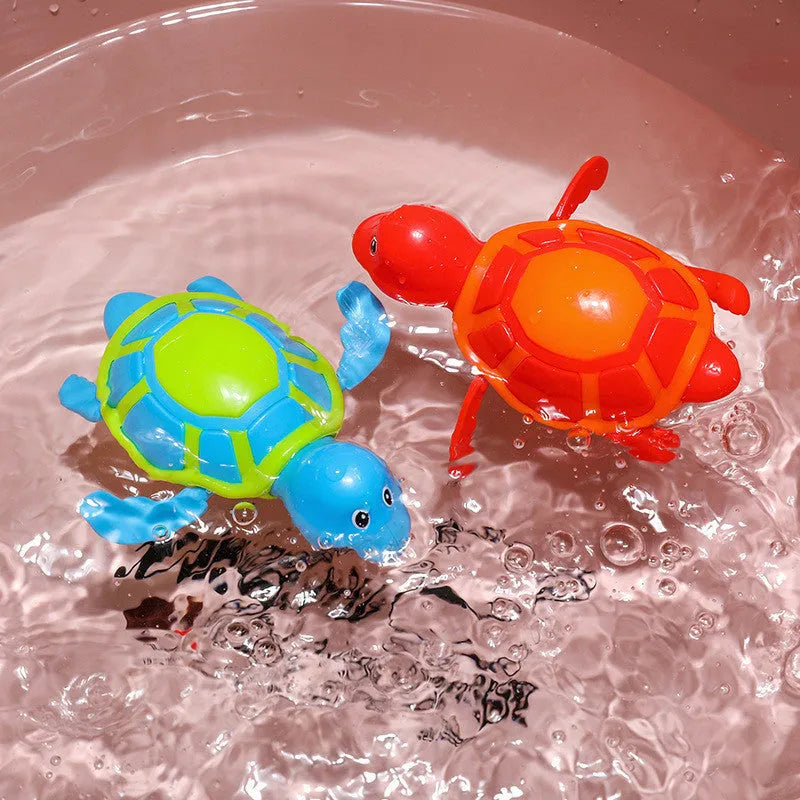 Plastic green turtle baby bath toy floating in water.