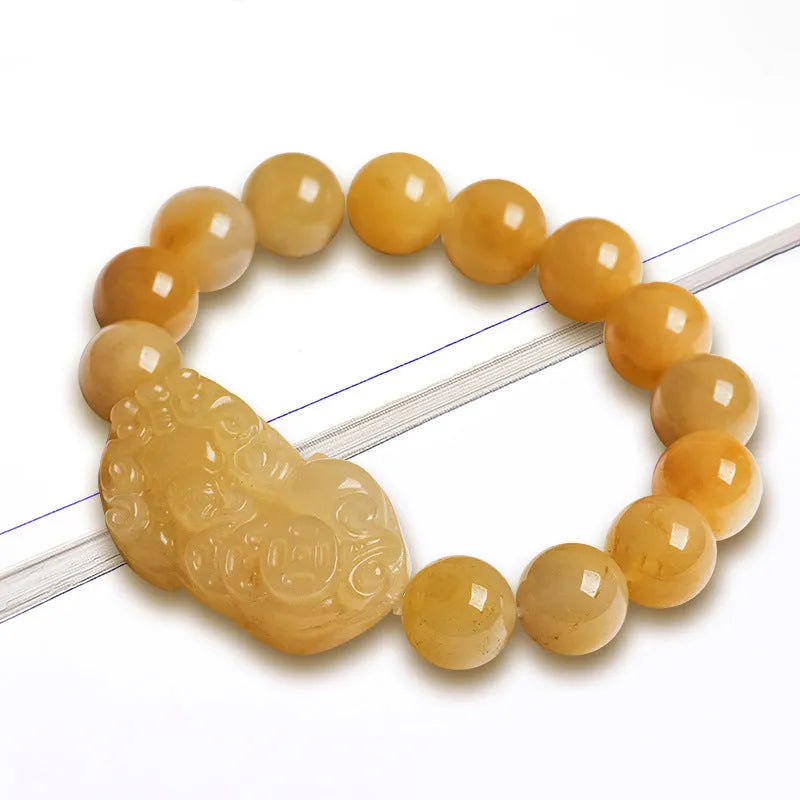 Golden Thread Jinsi Jade bracelet with a carved fortune coin and round jade beads in two size options.