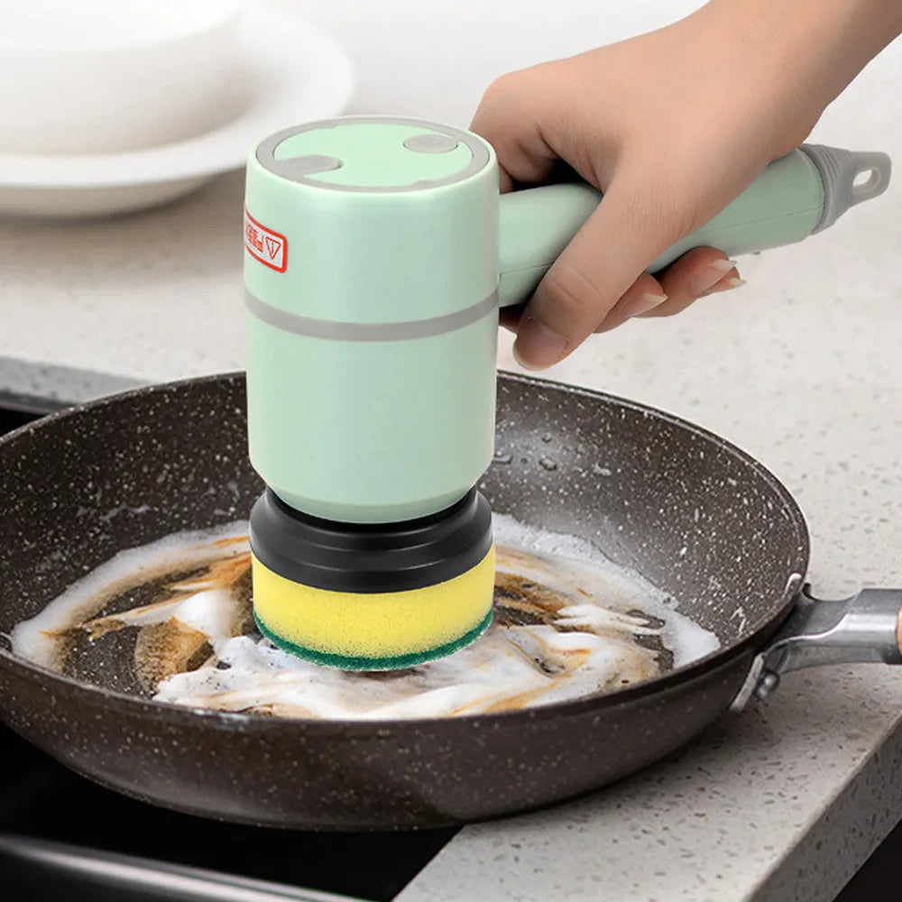 Green USB rechargeable electric cleaning brush with two brush heads on a kitchen counter
