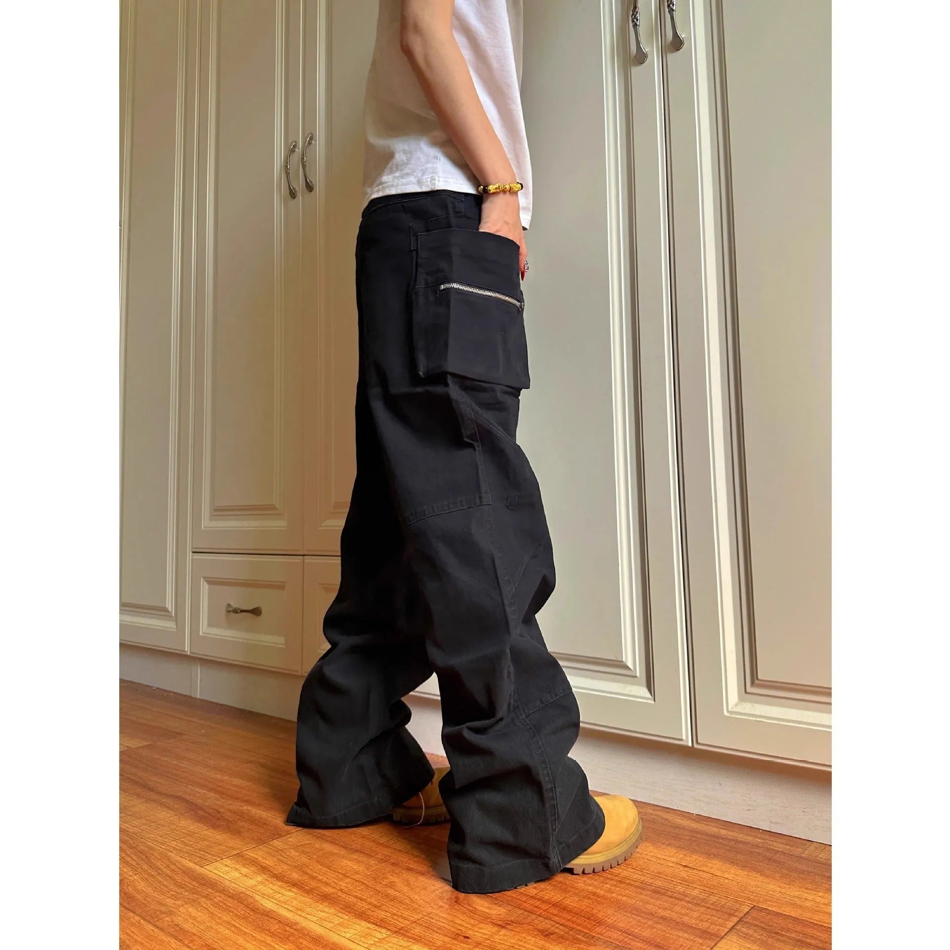 Green and black cotton casual trousers with double zipper detail and pockets on a mid-waist design.