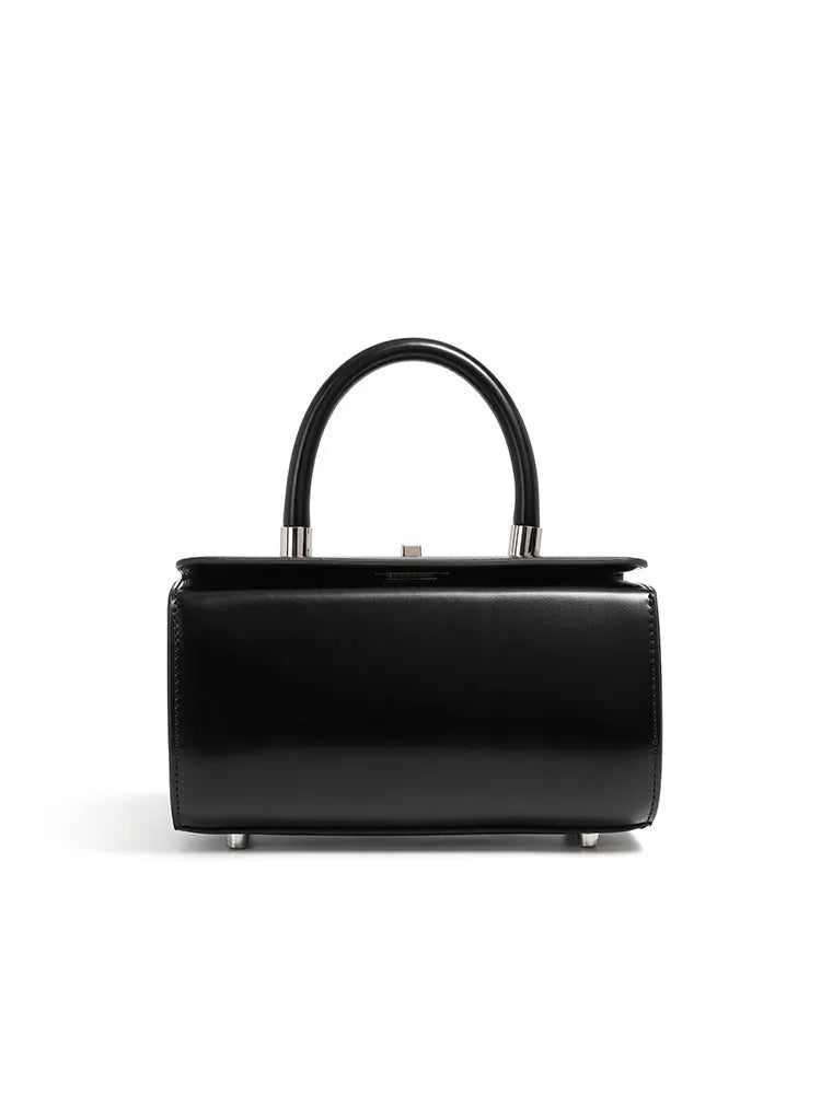 Brown leather women's crossbody bag with a single shoulder strap and clamshell opening.