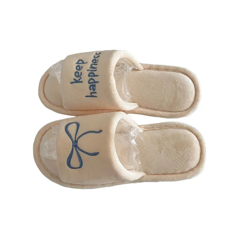 Ladies cotton slippers with suede upper, artificial wool lining, flat non-slip PVC sole, bow and letter detail, beige yellow pink black