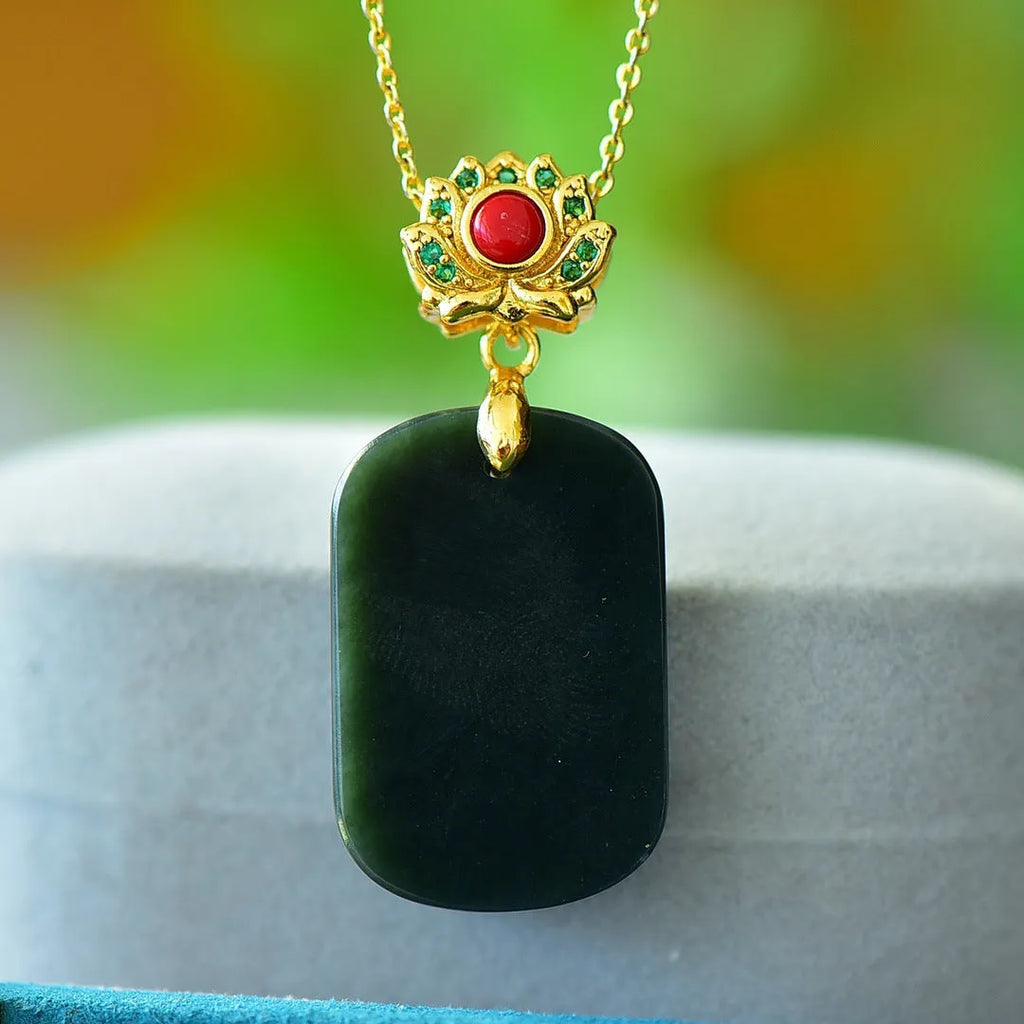 Flat Hetian jade pendant necklace with copper inlay on a gray background.