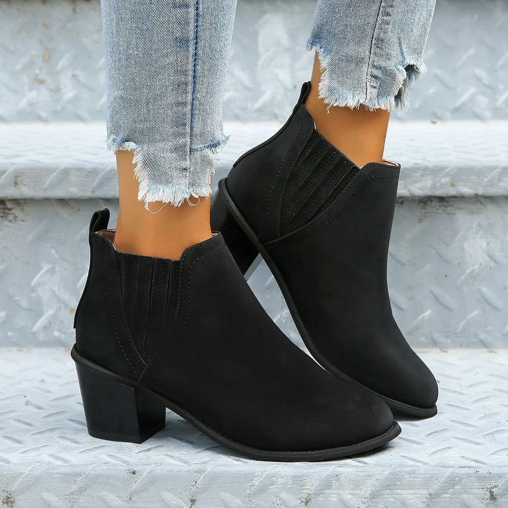Women's black ankle boots with pointed toe and thick square heel, slip-on design