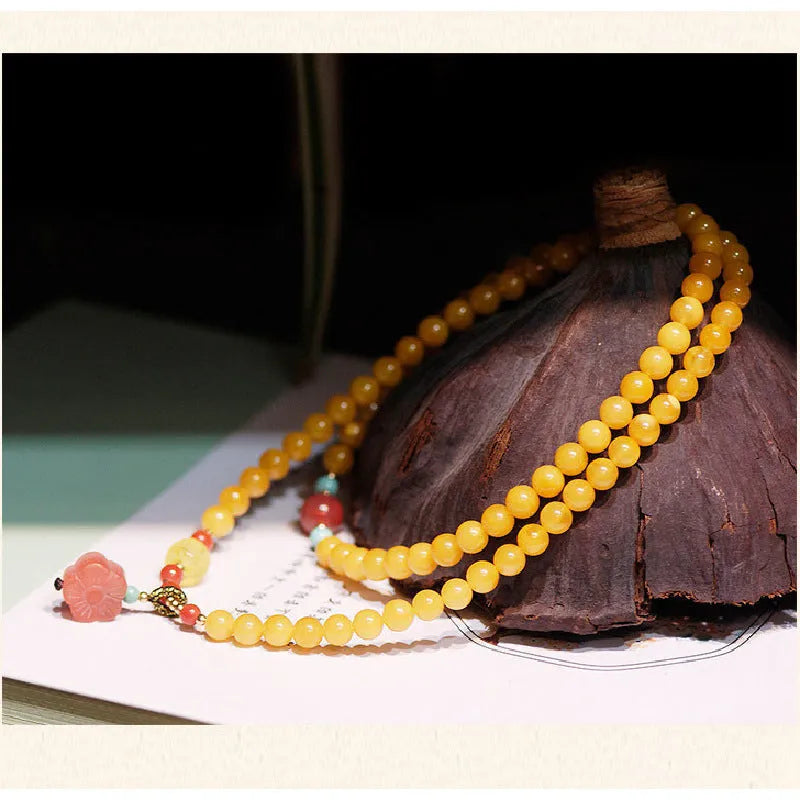 Amber bracelet with carved chicken zodiac charm and 5mm round fantasy crystal elements in retro style