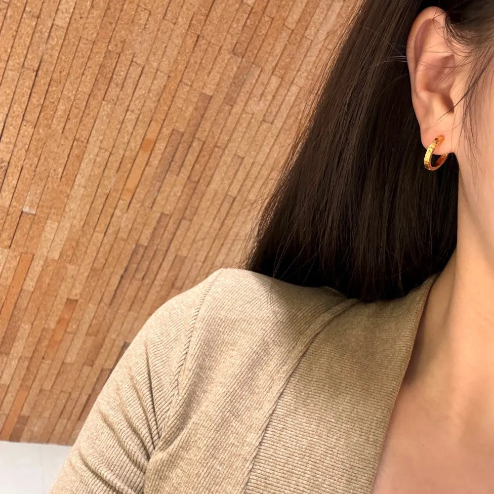 Pair of S925 sterling silver geometric scale stud earrings in gold finish with crushed ice texture