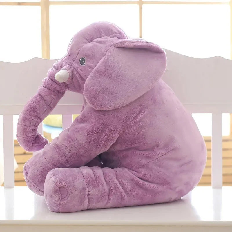 Grey elephant-shaped plush pillow cover for a child's bed, shown alongside blue and pink versions.