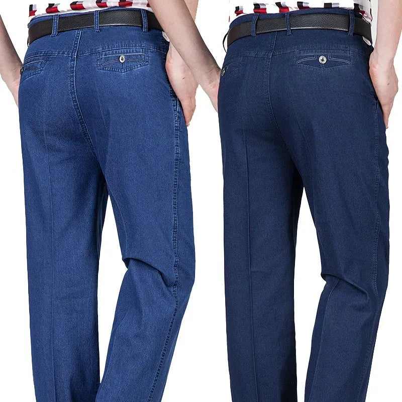 Men's loose fit high waist blue denim jeans on a plain background.