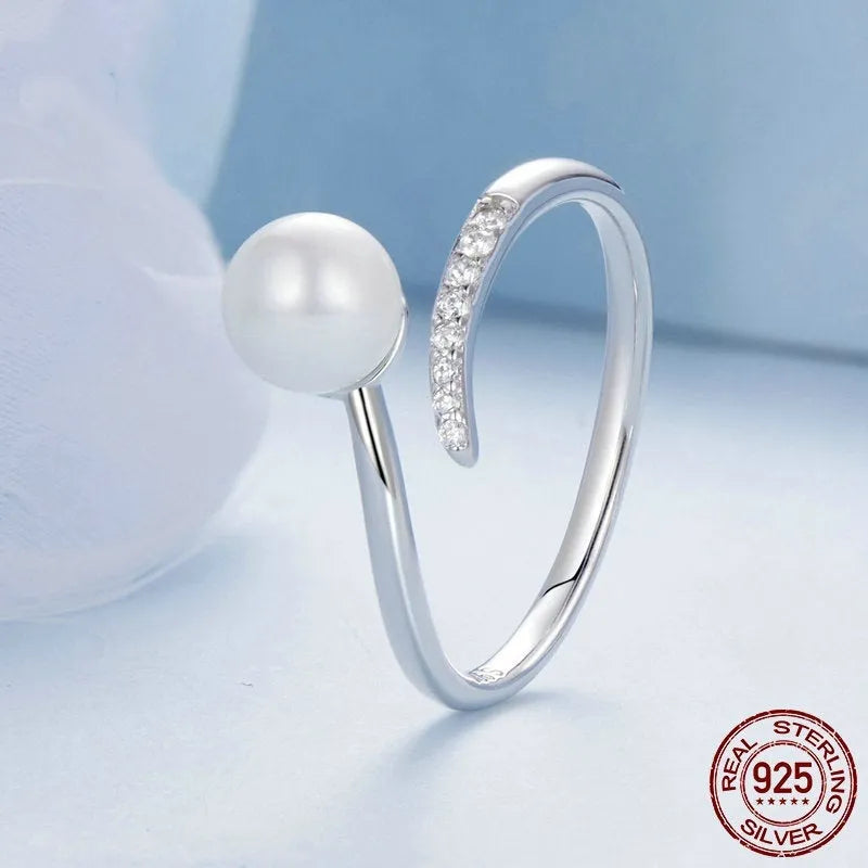 Women's S925 sterling silver adjustable ring with a natural pearl on an open loop.