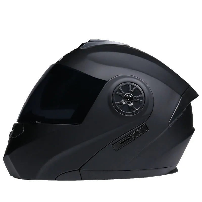 Matte black full face motorcycle helmet with integrated battery visor on a stand