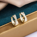Geometry-shaped copper earrings with zircon treatment in 14K yellow colour
