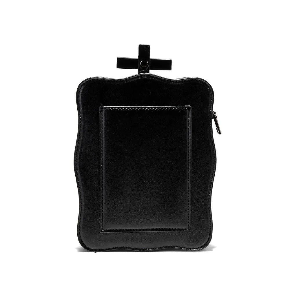Black mini square crossbody bag with embossed skull design and metal chain strap