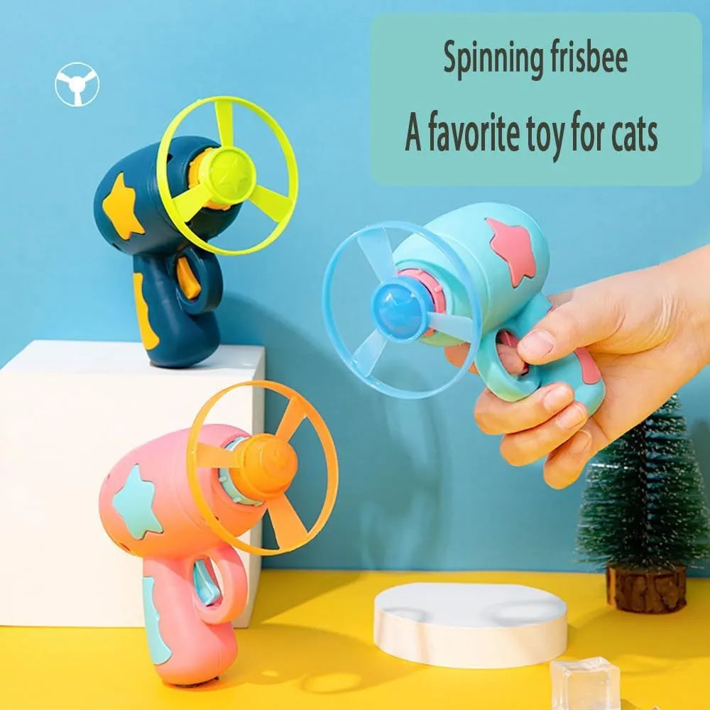 Blue plastic cat toy gun with spinning Frisbee ready for launch