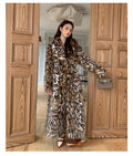 A long faux fur coat in street fashion style with a fur collar and pockets.