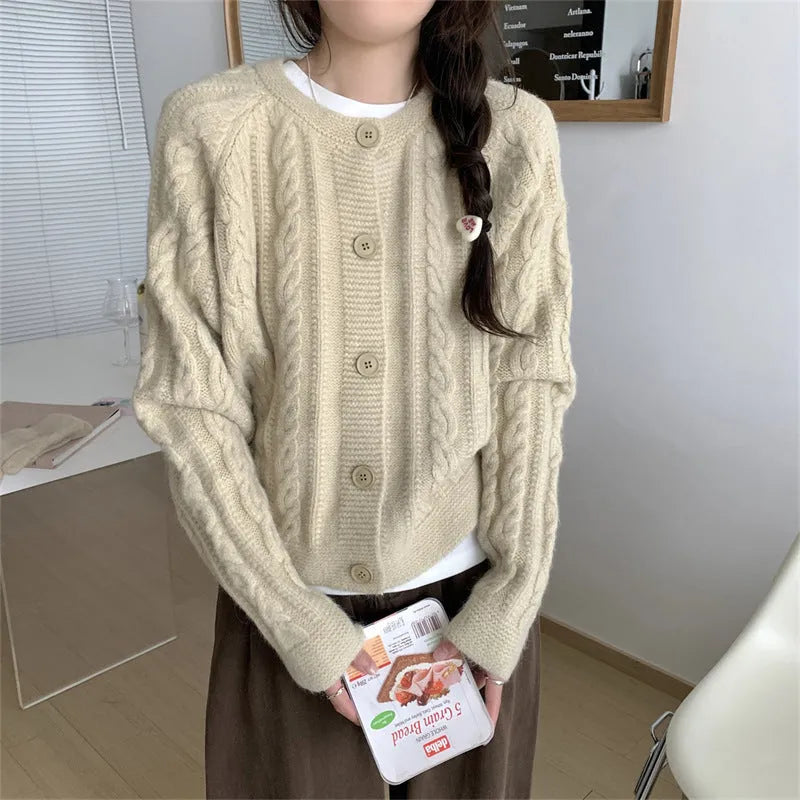 Women's loose-fit twist knit cardigan in solid colour with button front on a model