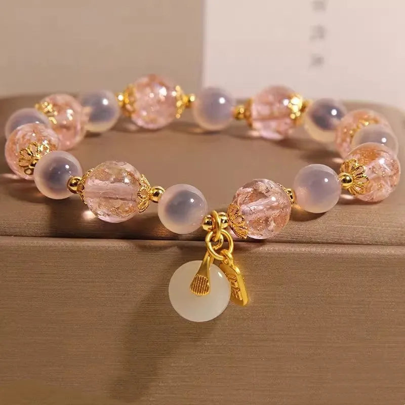 Women's pink heart agate bracelet with peace buckle closure and luminous glaze details