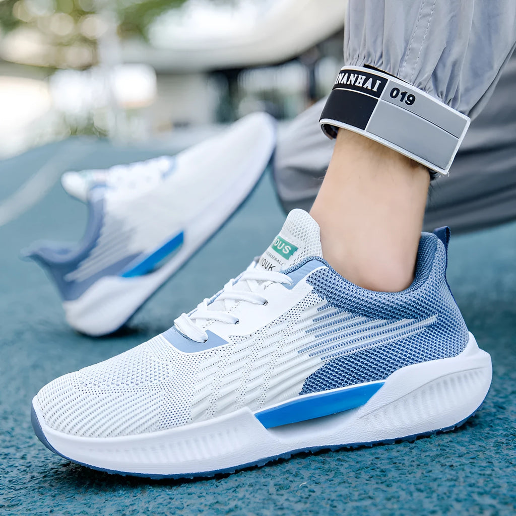 Men's blue casual sports mesh shoes with cloth upper and round toe design on a white background.