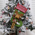 Three large Christmas stockings with Santa, Snowman and Reindeer designs hanging from a mantelpiece