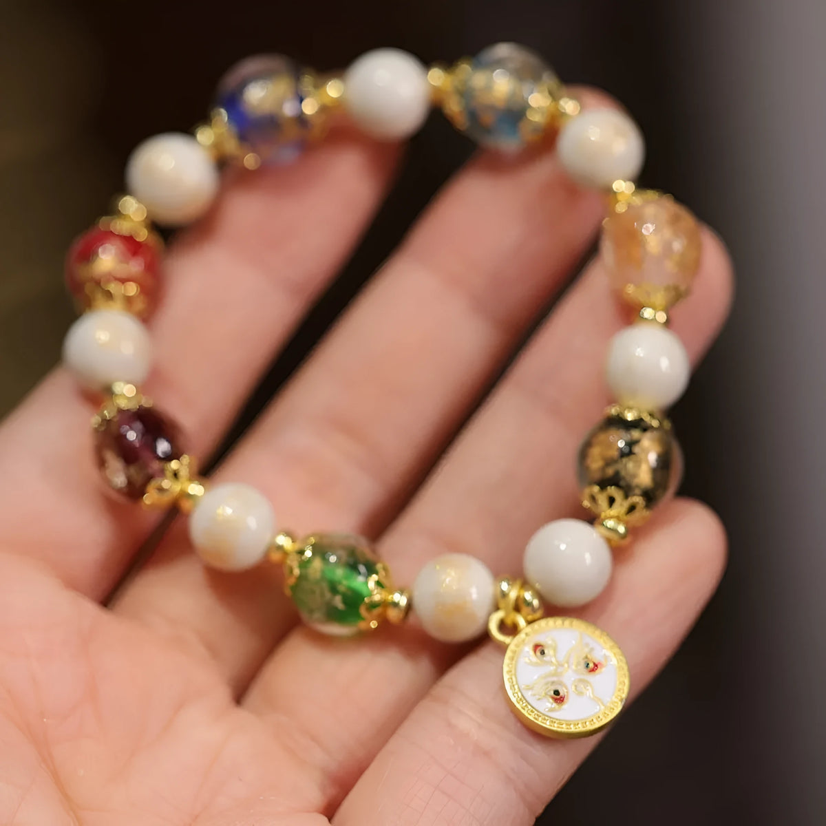 Handmade coloured glaze glass bracelet with Five Gods of Wealth geometric design in blue, green, red, white, or yellow.