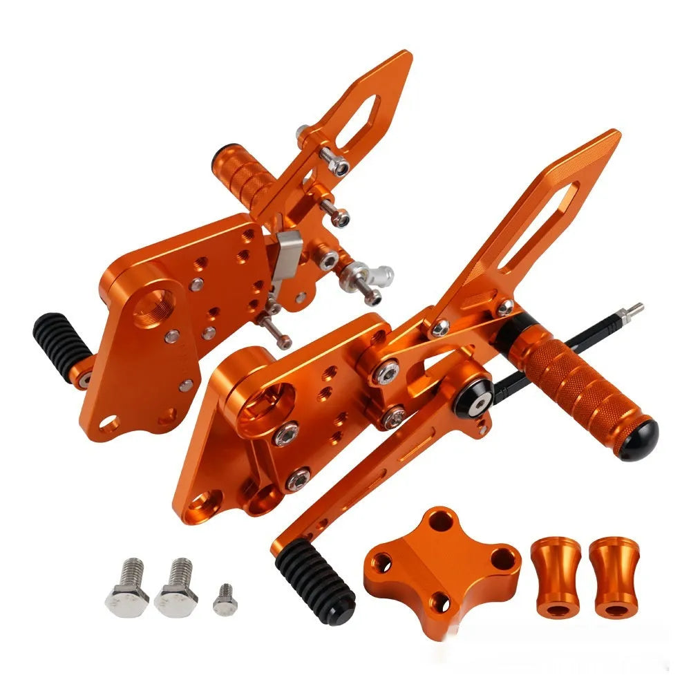 KTM Duke foot pedal bracket assembly for raised rear shift pedal in black or orange