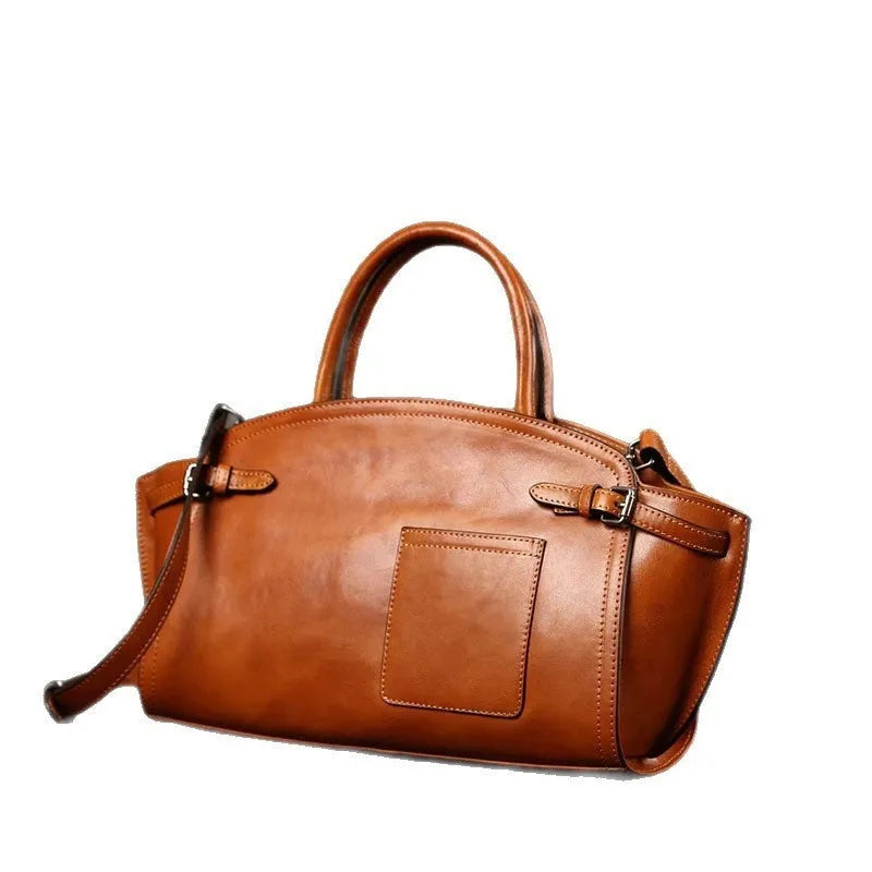 Genuine top grain leather women's crossbody bag in brown with dumpling shape and zip closure.