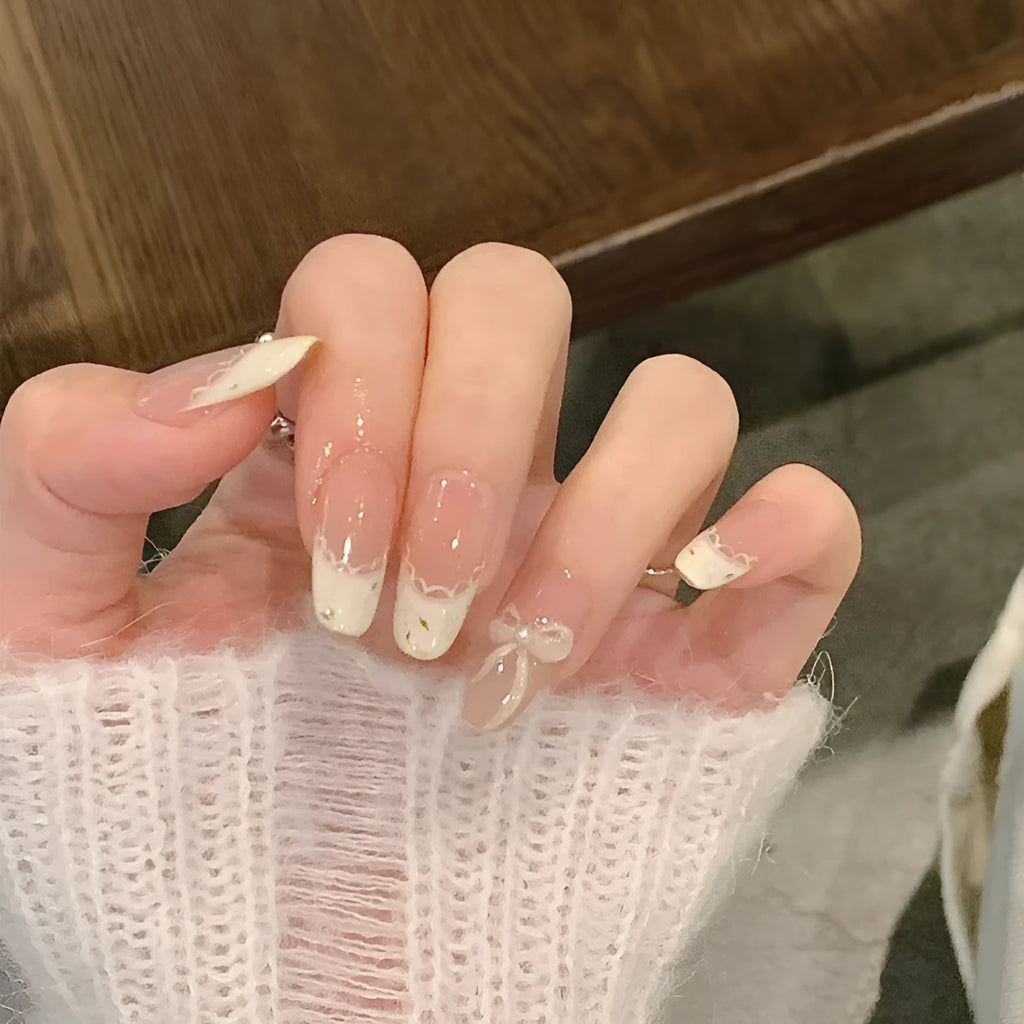 Medium length coffin-shaped fake nails in mixed colours with nail glue and application tools
