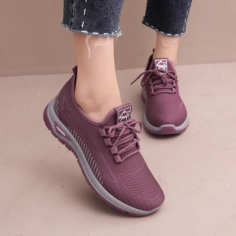 Women's round toe casual sneakers in black with breathable mesh and lace-up front
