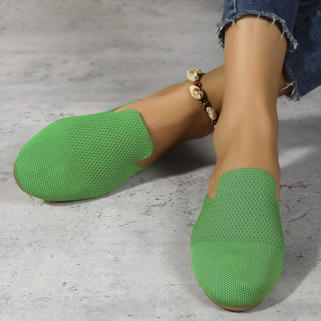 Apricot, blue, and green mesh slip-on flat sandals with round toe and cloth upper.