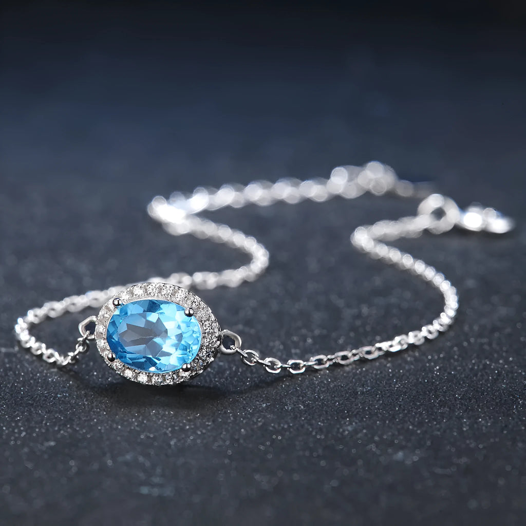Geometric sterling silver jewellery set with blue topaz gems including earrings, ring, pendant and necklace