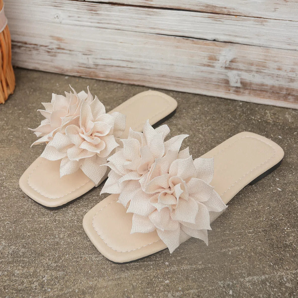 Women's flat flip-flops with flower detail on PU upper, available in apricot, black, white, red, and green
