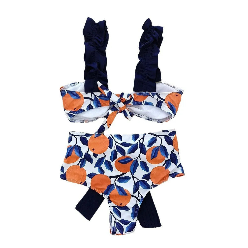 Blue leaf orange printed high waisted bikini swimsuit for women on mannequin