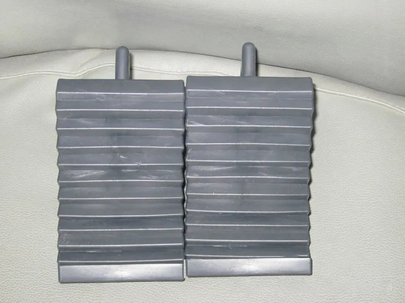 Car tyre skid stop parking locator set showing triangular anti-slip devices in black and silvery colours