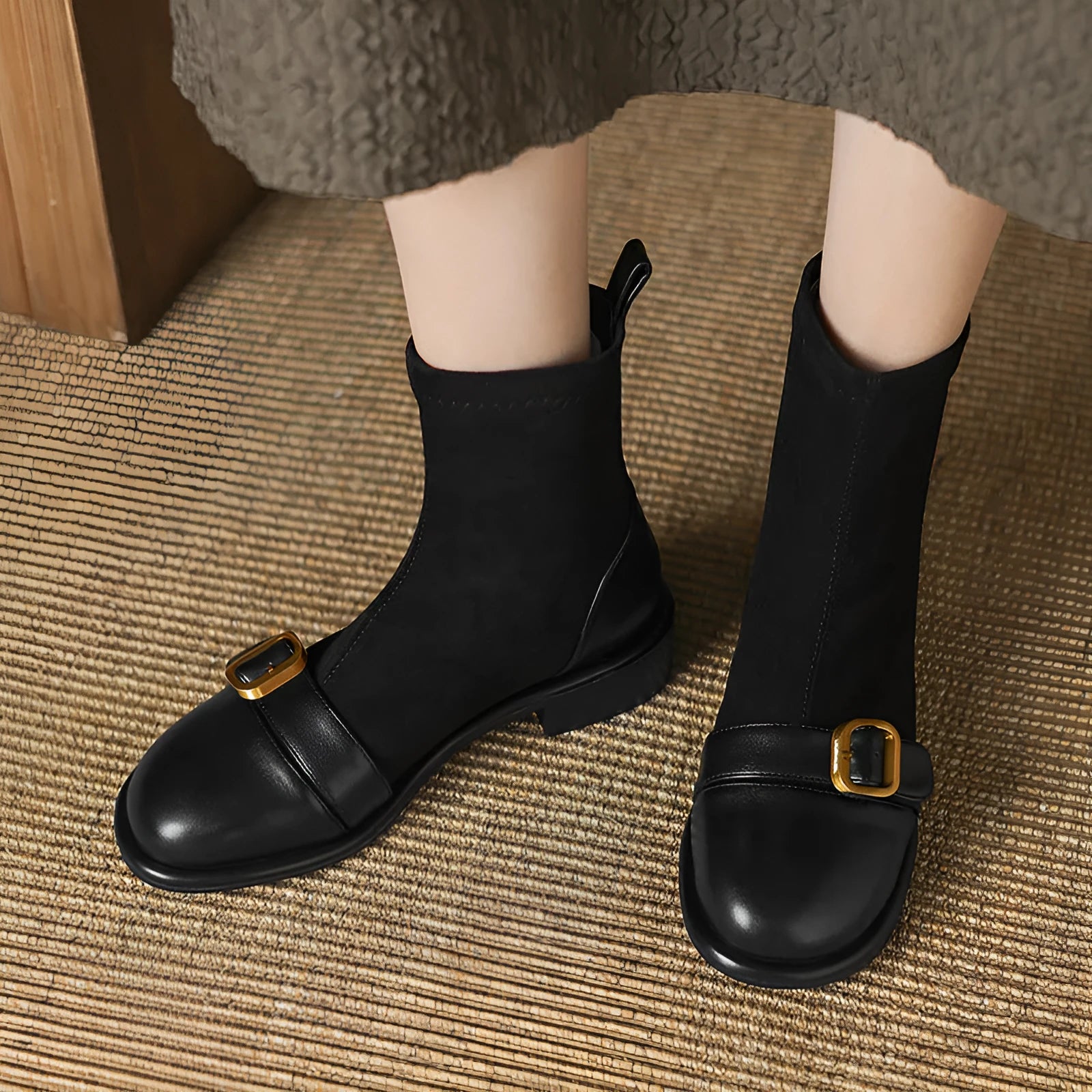 Women's black low heel Martin boot with lace-up front and decorative buckle stitching on a round toe.