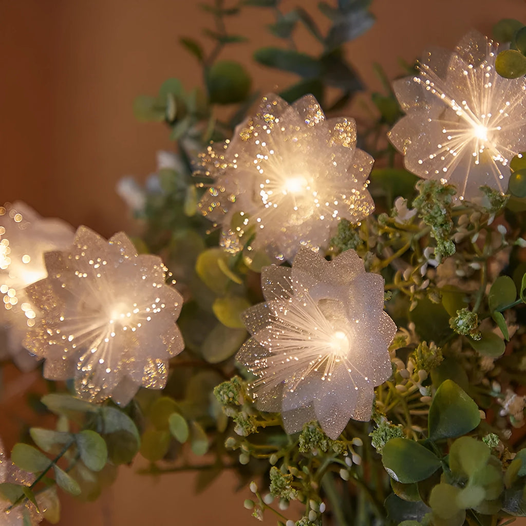 LED optical fibre flower light string with 20 warm white flower-shaped beads on a dark background